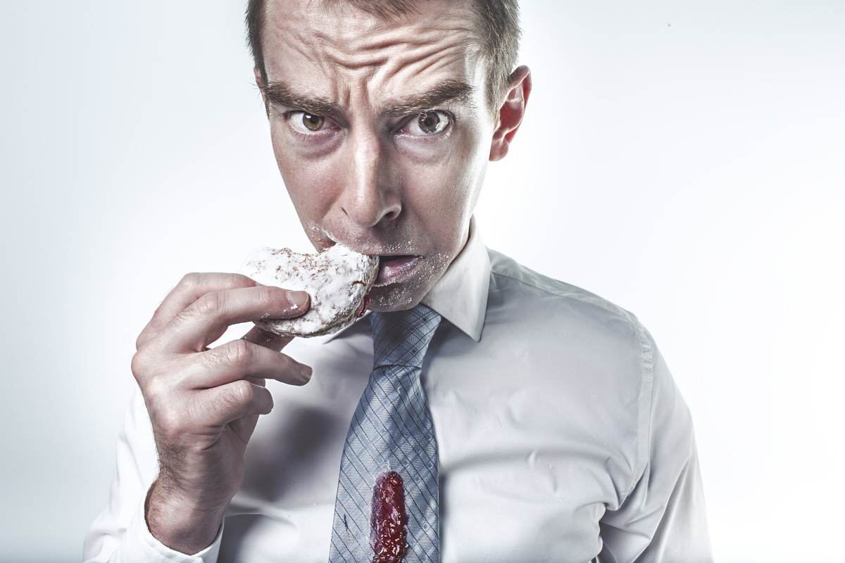 you must ask about cookies on a website - tongue in cheek man eating a cookie with a guilty look on his face