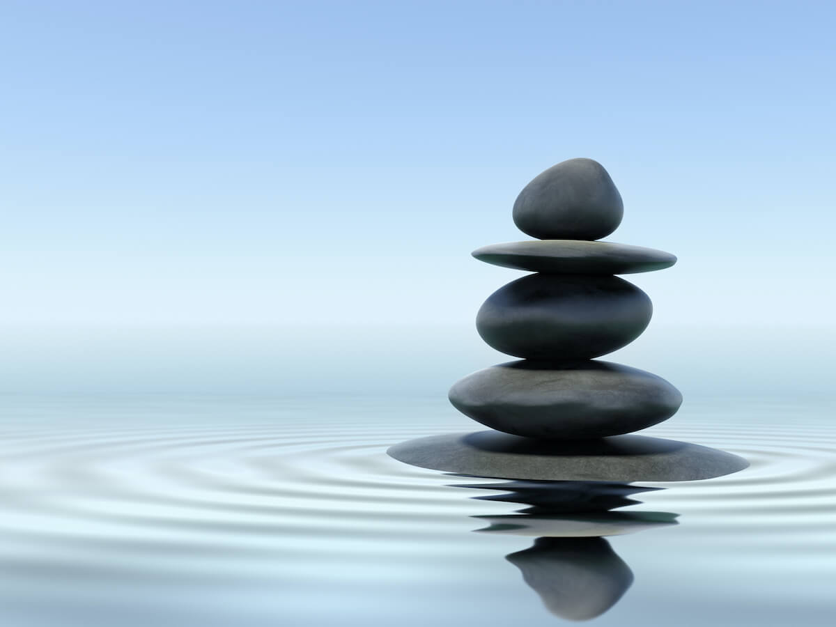 rocks balanced on a pond representing a mind body approach
