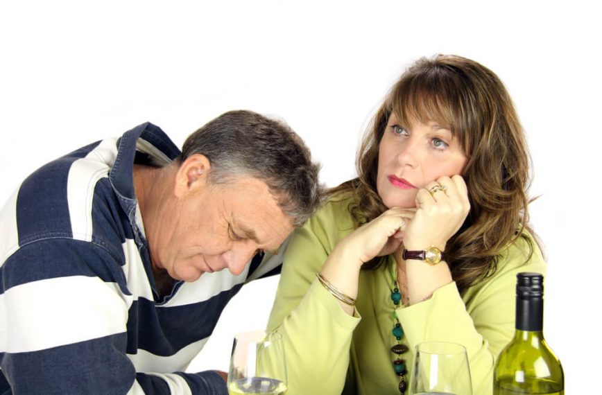 discouraged couple in front of wine lamenting over repetitive relationship patterns showing how unhealthy their relationship is