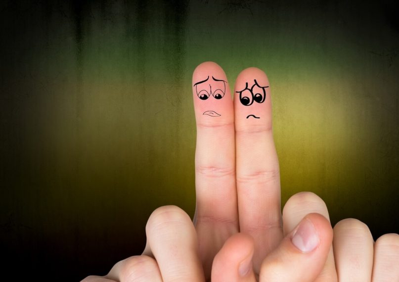 two fingers side by side with sad faces because I don't laugh anymore