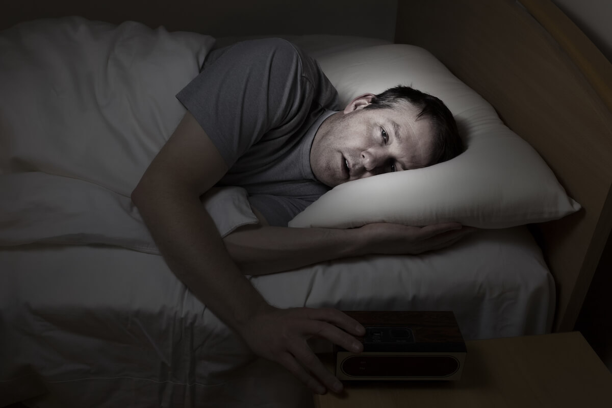 middle aged white guy looking haggard in bed