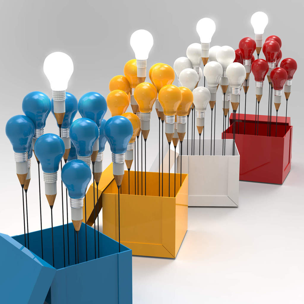 four colored open boxes each holding light same colored bulbs on sticks that have pencils as the holder of the bulbs sorry this is hard to describe