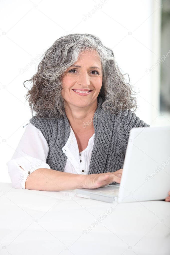 a photo of an older pretty woman in front of her laptop seemingly happy with her results dealing with transference using therapy bootcamp